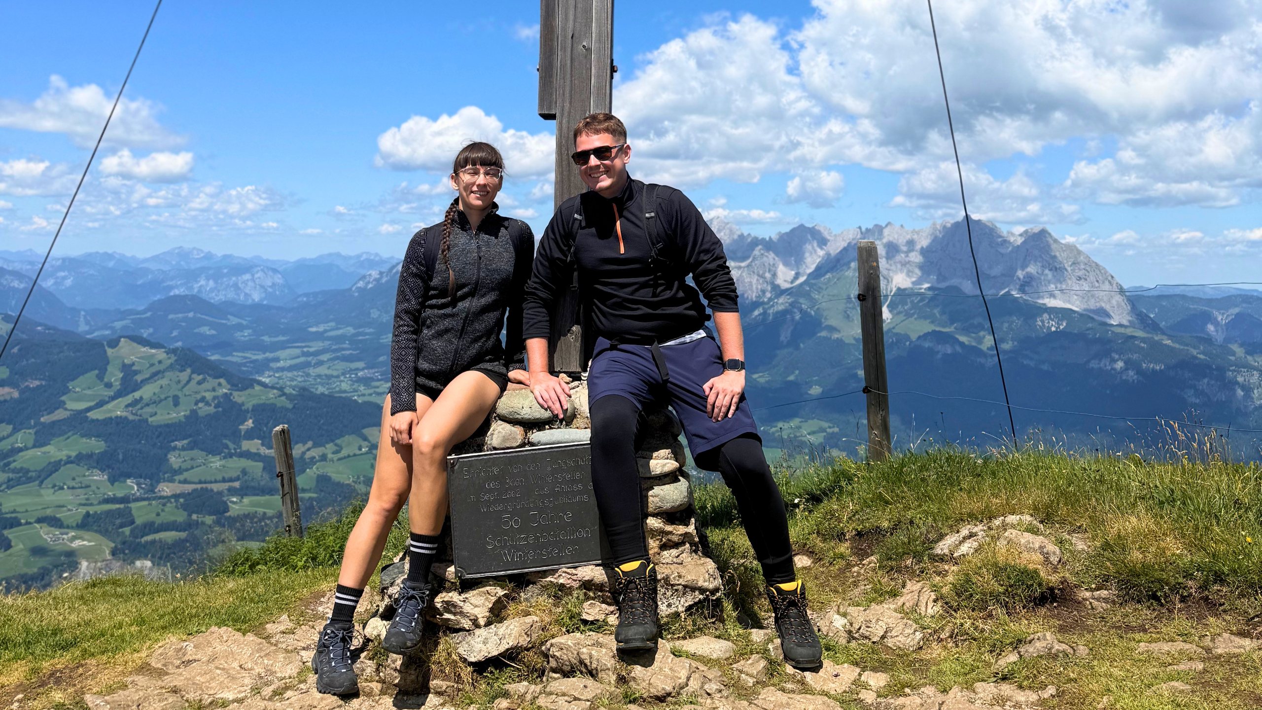 Martin Sevcik and his fiancée at a summit cross above Kitzbühel